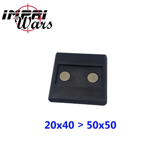 Adaptador negro rectangular de peana con dos imanes redondos visibles.