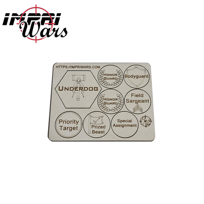 Plancha de tokens de DM con marcadores de objetivos y asignaciones grabados.